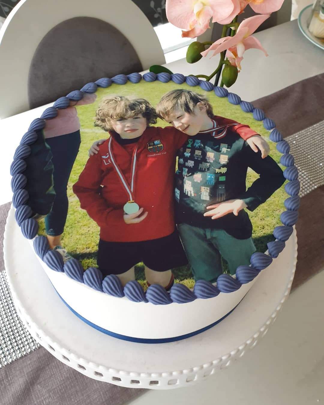 Own image cake topper of two boys arm over each others shoulders